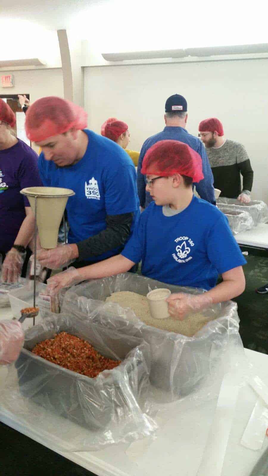 Scouts packing food for Rise Against Hunger